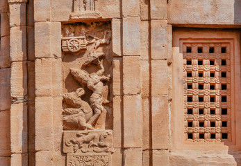 Krishna Lord on relief of historical temple in India. Architecture of 7th century with carved walls in Pattadakal, Karnataka state