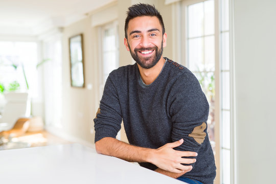 Handsome man smiling cheerful with a big smile on face showing teeth, positive and happy expression