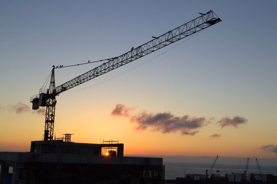 Construction crane against the sunset sky in Antofagasta, Chile