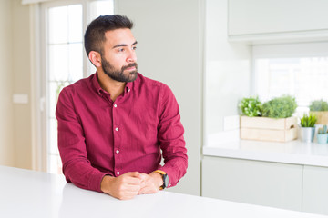 Naklejka premium Handsome hispanic business man looking to side, relax profile pose with natural face with confident smile.