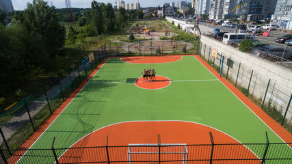 Obraz premium Soccer field among tall houses.