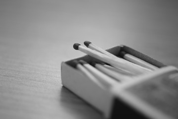 open cardboard box with matches on the table, black and white photo