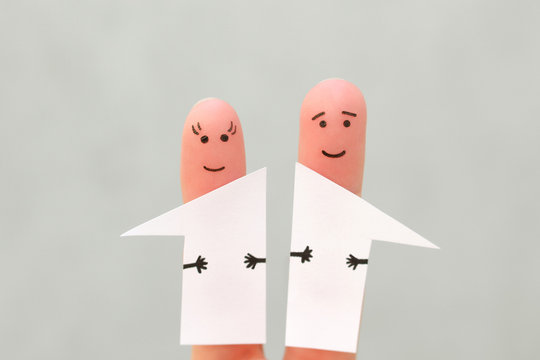 Fingers art of family after divorce. Concept of man and woman divided house in half.