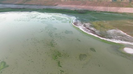 AERIAL SHOT CRIMEA MARCH 2019 Water surface with algae and white coast Marshland with native patterns
