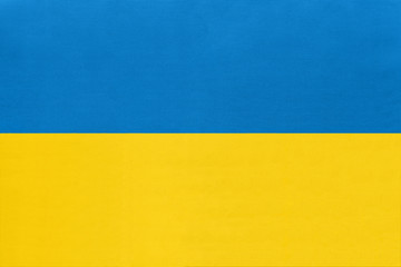 Ukraine national fabric flag, textile background. Symbol of international world european country.
