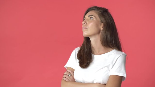 Girlfriend acting offended and moody. Insulted cute sulking adult woman in white t-shirt, cross hands chest, frowning turn head aside, raising nose snobbish and arrogant, stand red background
