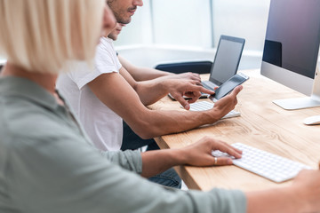 close up. young employee choosing a contact on his smartphone.