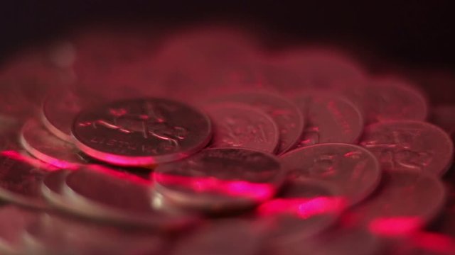 Close Up Of Rotating Lithuanian Aluminum Cent Coins Illuminated By Red Laser Light,