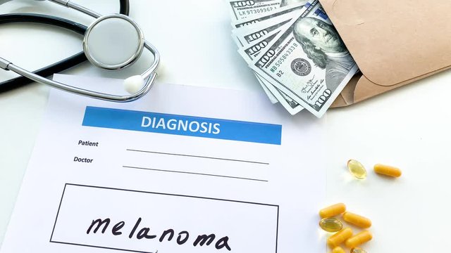 Diagnosis melanoma in a medical form on the doctor desk