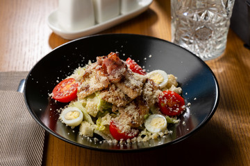 Warm salad with meat and eggs, food close-up