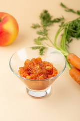 Apple and carrots jan in glass bowl