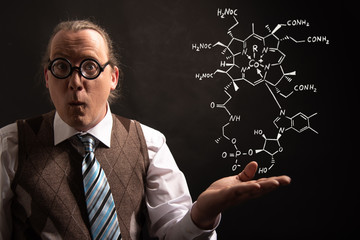 Professor presenting handdrawn chemical formula of Vitamin B12