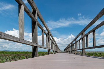 Wooden bridge over a lake with blue sky in Sam Roi Yod National Park, Prachuap Khiri Khan, Thailand