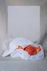 Apples in a plastic bag on the table place for text