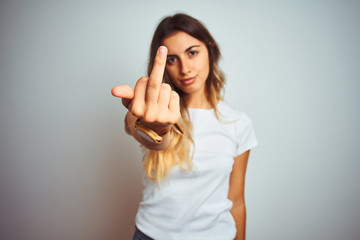 Young beautiful woman wearing casual white t-shirt over isolated background Showing middle finger,...