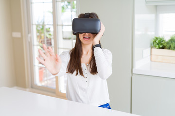 Young woman playing virtual reality game using simulation glasses headset, funny and amazing entertainment