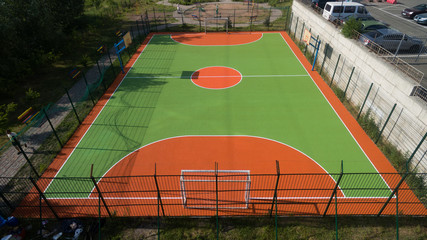 Fototapeta premium Soccer field among tall houses.