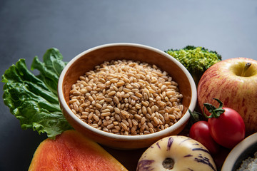 Fresh seasonal fruits, vegetables and wheat close-up