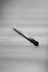 one used match on the table, black and white photo