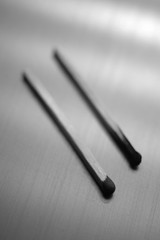 one used, and the other new matches on the table, black and white photographs