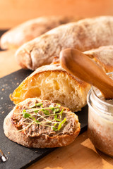 Food Concept french beefs Rillettes  spread on homemade crusty artisan ciabatta bread with flax microgreen for breakfast or breaking snack