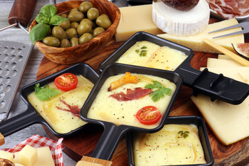 Delicious traditional Swiss melted raclette cheese on diced boiled or baked potato and baguette...