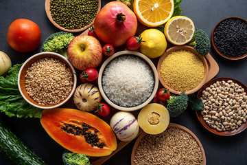 Full screen of fresh seasonal fruits and vegetables and whole grains