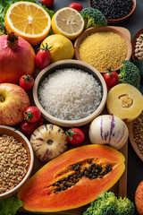 Full screen of fresh seasonal fruits and vegetables and whole grains
