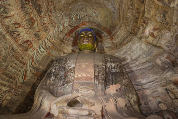 Looking up at a Buddha statue in cave 6 of the Yungang Grottoes near Datong