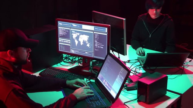 Internet fraud, darknet, data thief, cybercrime concept. Hacker attack on government server. Criminals coding virus programs.