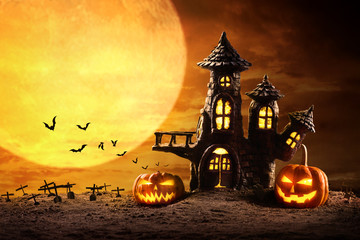 Halloween pumpkins and Castle spooky in night of full moon and bats flying