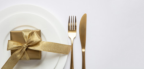 Table setting, xmas, new year. Gold cutlery on white set of dishes, white background