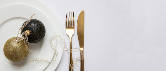 Table setting, xmas, new year. Gold cutlery on white set of dishes, white background