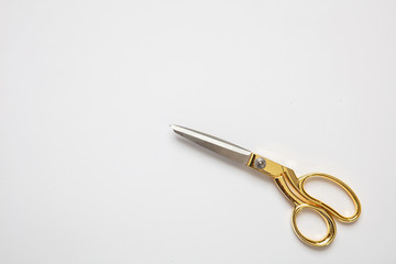 Scissors gold and silver isolated against white background
