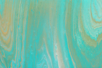 photography of abstract marbleized effect background. turquoise, gold, blue and white creative colors. Beautiful paint.