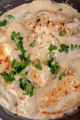 Creamy mushroom chicken breast in a pan. top view, close up