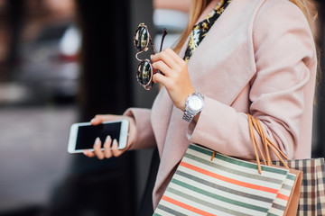 Close up photo. Focus at details, shopping concept, woman in luxury clothing.