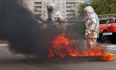 Fiteman in a fire proximity suit puts on fire.Fireman in a fire proximity suit which made to...