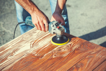 man polishing boards