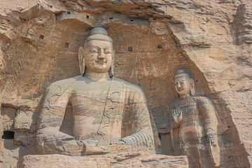 Close up of two Buddha statues in a niche in the Yungang Grottoes near Datong