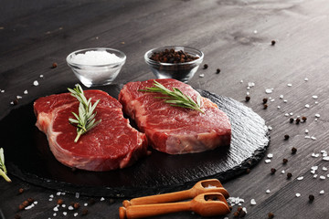 Steak raw. Barbecue Rib Eye Steak or rump steak on dark rustic table