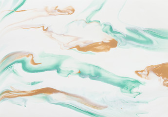 photography of abstract marbleized effect background. gold, mint and white creative colors. Beautiful paint