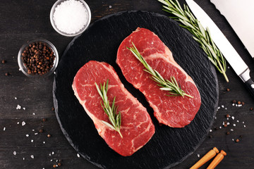 Fototapeta na wymiar Steak raw. Barbecue Rib Eye Steak or rump steak on dark rustic table
