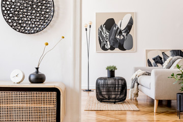 Scandinavian and design home interior of living room with wooden commode, gray sofa design black...