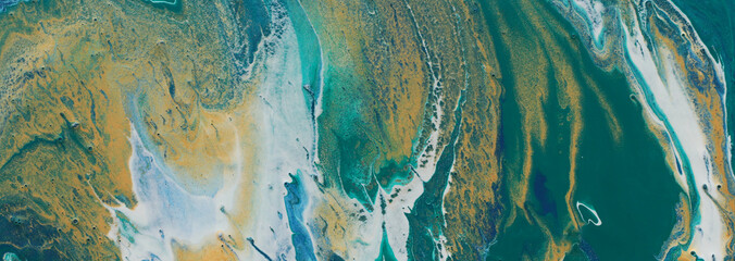 art photography of abstract marbleized effect background. turquoise, emerald green, blue and gold...