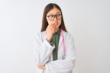 Young chinese dooctor woman wearing glasses stethoscope over isolated white background looking stressed and nervous with hands on mouth biting nails. Anxiety problem.