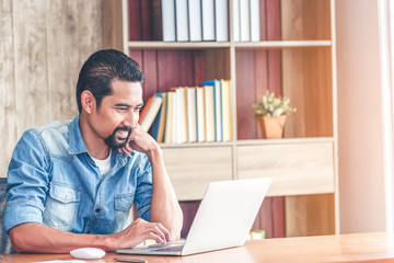 Handsome asian businessman smiling after receipt a goods news or get new work project. Young business people working at home.