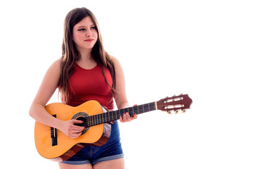 Teenage girl playing a Spanish guitar, young artist with her musical instrument, isolated