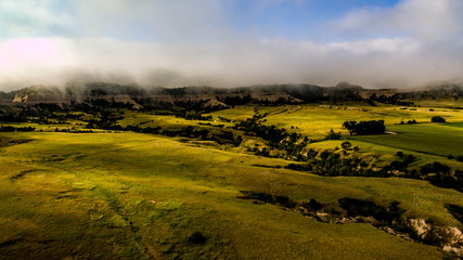 Sunrise over Scottsbluff, Nebraska with low clouds, fog, and blue sky