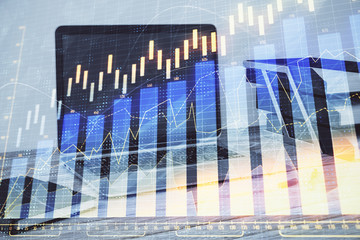 Stock market chart and desktop office computer background. Multi exposure. Concept of financial...